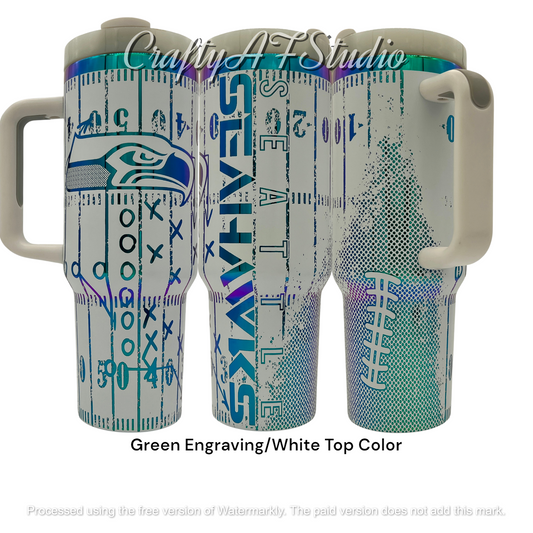 40oz Seattle Seahawks themed laser engraved tumbler. Logos with distressed field and football. Green engraving with white top color