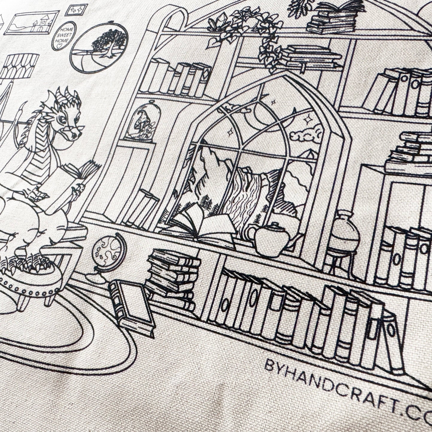 Black and white illustration of a cozy room with books and a dragon, featuring 'ByHandcraft.co' branding.
