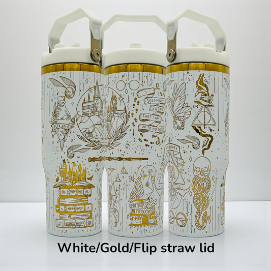 Three white bottles with gold designs featuring magical motifs and flip straw lids.