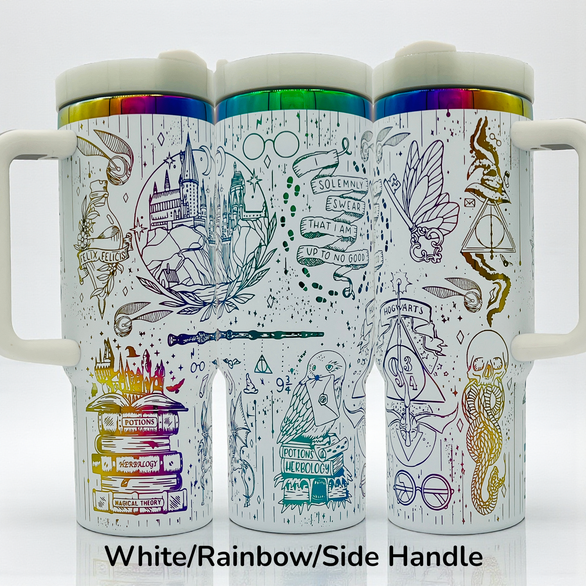 White mugs with rainbow lids, featuring intricate black magical-themed illustrations and symbols.