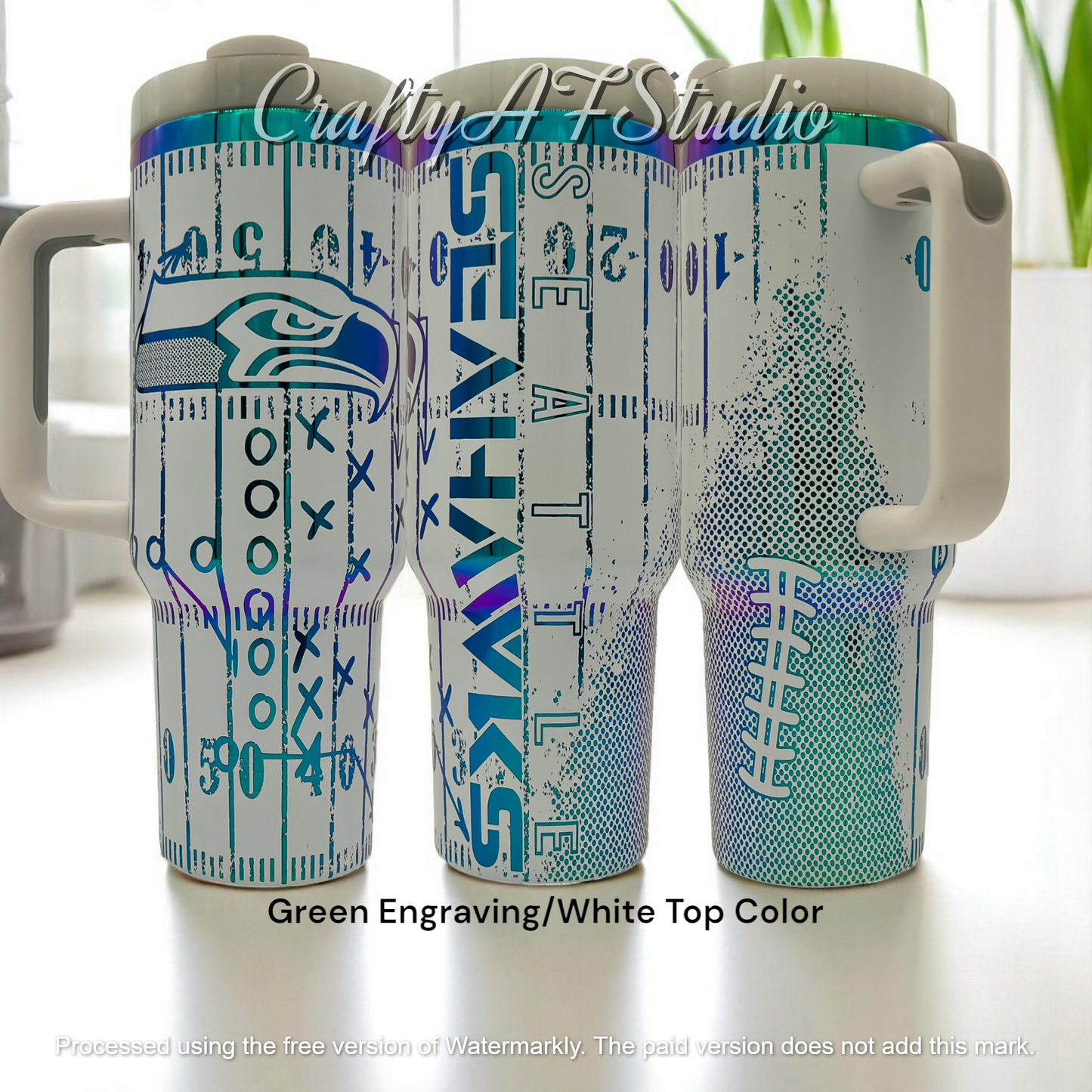 40oz Seattle Seahawks themed laser engraved tumbler. Logos with distressed field and football. Green engraving with white top color