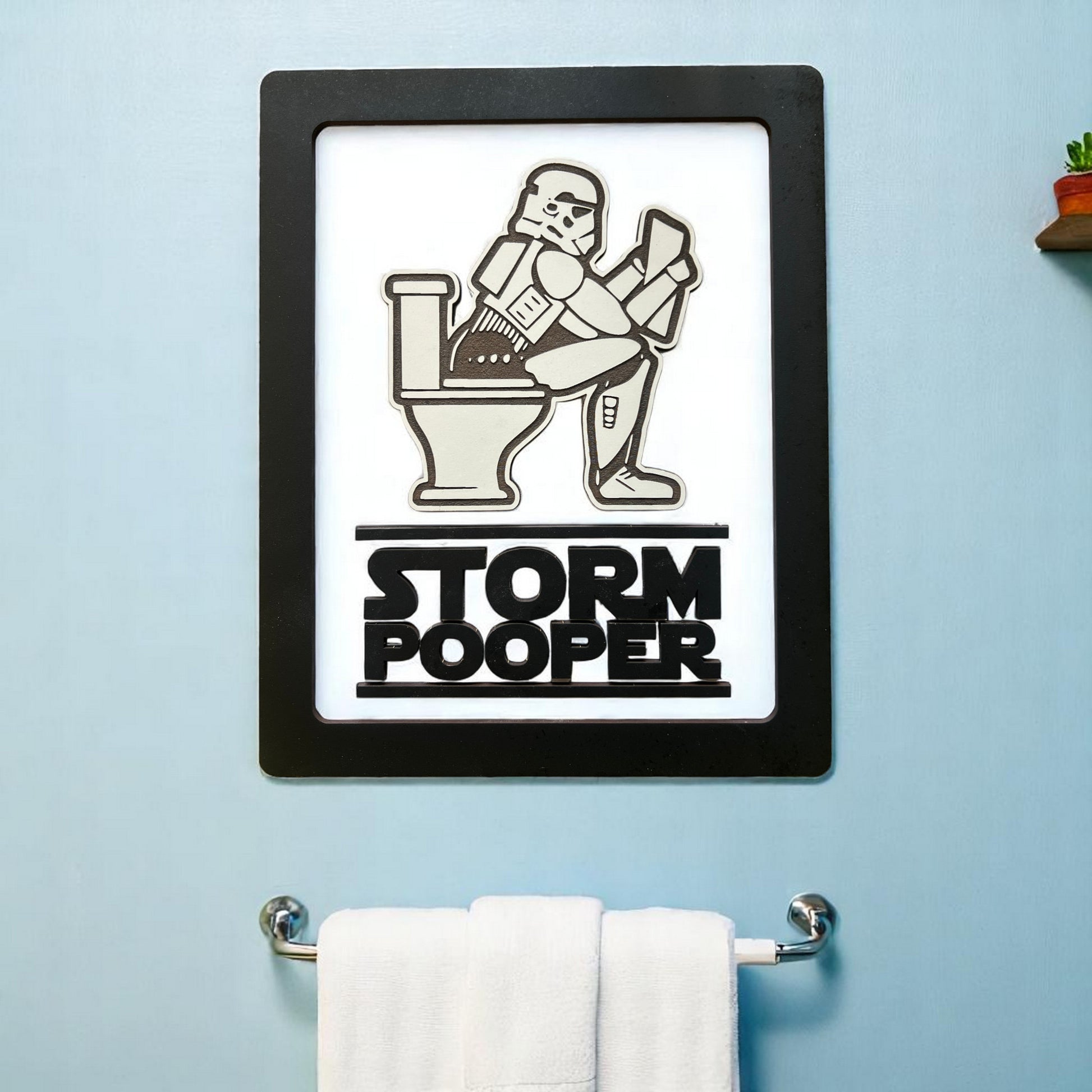 Embrace your inner Jedi—or Sith—with our whimsically powerful Storm Pooper&nbsp;Bathroom Sign. Crafted from three layers of 1/8-inch wood, this sign is not only a conversation starter but a work of art! Its built-in hanger ensures it lays flat against your wall, making it a seamless addition to your bathroom decor. Whether you're a fan of the dark side or simply want to add a touch of the Force to your space, this sign is the perfect blend of fun and function. 