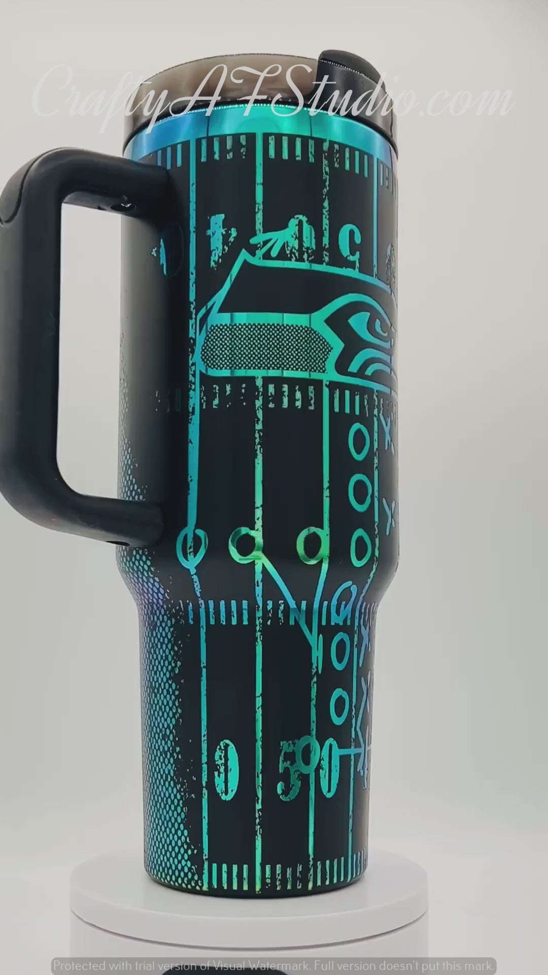 40oz Seattle Seahawks themed laser engraved tumbler. Logos with distressed field and football. Green engraving with black top color