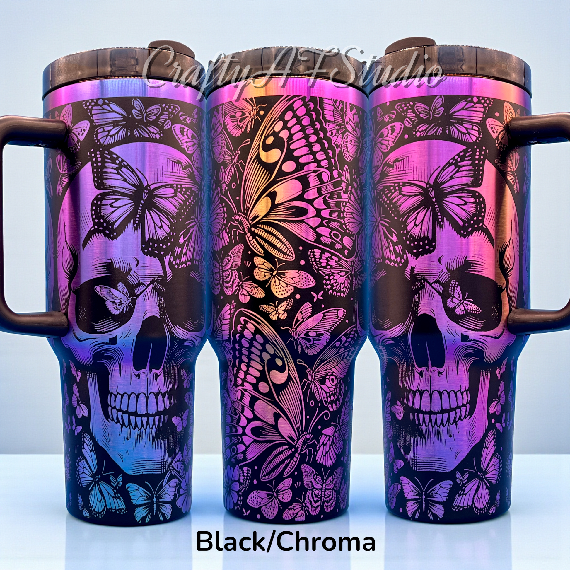 travel mug with black skull and butterfly designs on a vibrant purple and pink gradient.