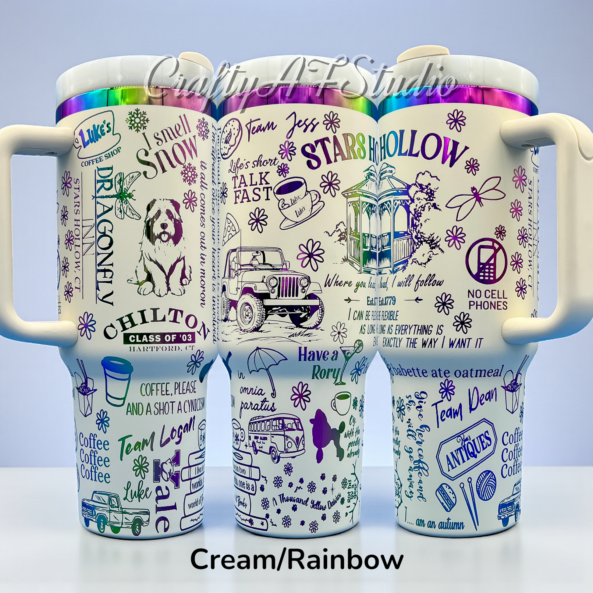 Three cream mugs with rainbow lids, featuring purple sketches and text of various icons and phrases.